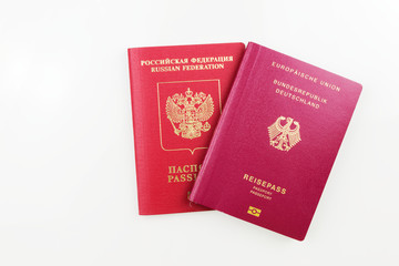 Russian passport behind German passport isolated on white background