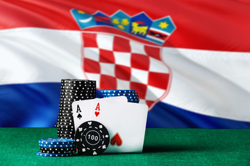 Croatia casino theme. Two ace in poker game, cards and black chips on green table with national...