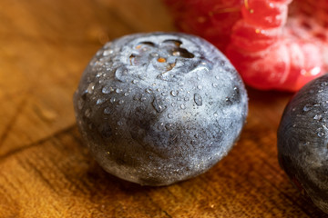 Close up macro photo of a blueberry with water droplets