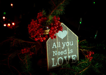 Christmas toys, with green Christmas tree on dark background with lights