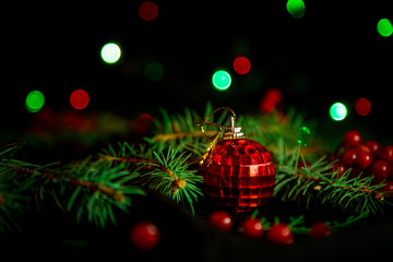 Fototapeta na wymiar Christmas toys, with green Christmas tree on dark background with lights