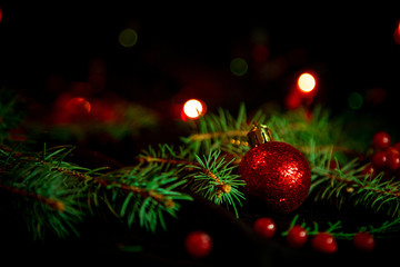 Christmas toys, with green Christmas tree on dark background with lights