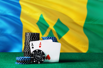 Saint Vincent And The Grenadines casino theme. Two ace in poker game, cards and black chips on...