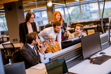 Senior businesswoman working together with young business people in modern office