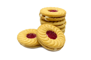 Biscuit sandwich butter cookies with cream and strawberry flavoured jam. A stack of crunchy delicious sweet meal and useful cracker. isolated on white background. Soft focus.