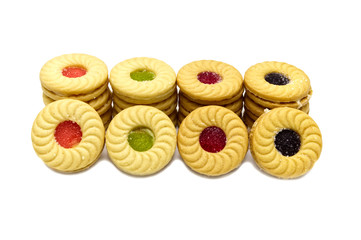 Biscuit sandwich butter cookies with cream and mixed fruits flavoured jam. A stack of crunchy delicious sweet meal and useful cracker. isolated on white background. Soft focus.