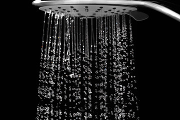 Water jets from the shower on black - obrazy, fototapety, plakaty