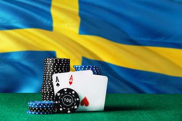 Sweden casino theme. Two ace in poker game, cards and black chips on green table with national flag...