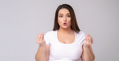 Plus Size Model with long hair meditates in studio.