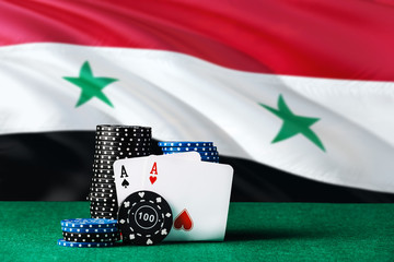 Syria casino theme. Two ace in poker game, cards and black chips on green table with national flag...