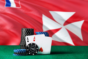 Wallis And Futuna casino theme. Two ace in poker game, cards and black chips on green table with...