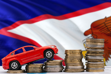 American Samoa savings concept. Money for new automobile, toy car and coin piles standing on...