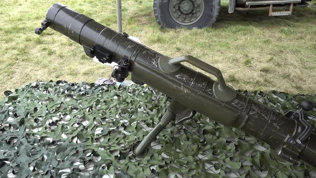 Soldier Walking By Bazooka On Table With Camoflauge Left To Right Pan