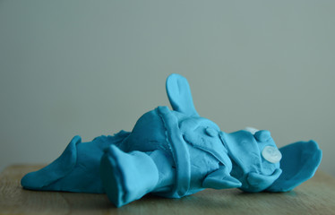 a small blue character made out of playdough