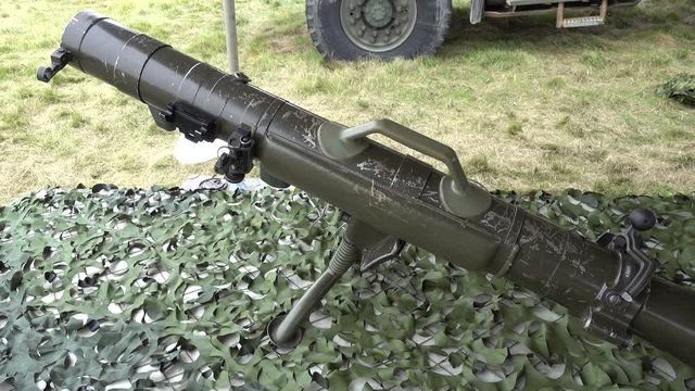 Soldier Walking By Bazooka On Table With Camoflauge Right To Left Pan