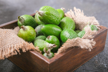 Harvest. Feijoa fruit in a wooden plate on a cutting kitchen board.