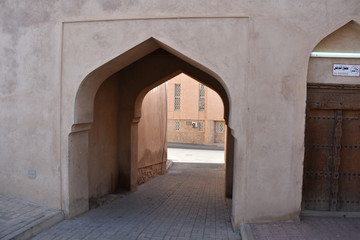 Fototapeta na wymiar Covered Driveway with Arabesque Arch, Nizwa, Oman