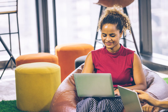 Working woman sitting on sofa in living room office co working place