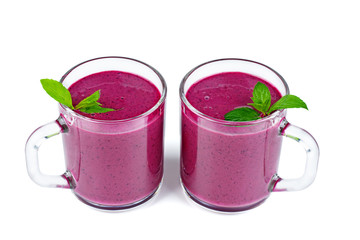 Glass of homemade blueberries smoothie and fresh mint leaf