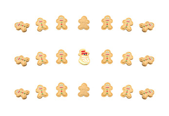 on a white background, sweet cookies in the form of a snowman and Santa Claus, with icing and colorful dragees, are laid out in three rows