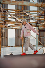 Fototapeta premium Young male staying against the background of metal structures