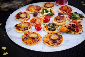 Home made pizza and mini pizza on the table