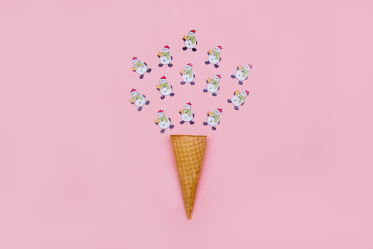 Lots of little snowmen and a waffle cone on a pink background