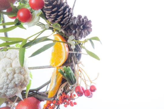 Fruit and Vegetable Christmas themed Ornamental Wreath on a White Background with copy space