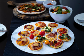 Home made pizza and mini pizza on the table