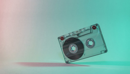 Beautiful Audio cassette tape in neon  light.Minimalism retro style concept. 80s. Background...