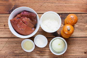 Step-by-step preparation of beef stroganoff from beef liver, step 1 - preparation of ingredients, top view, selective focus