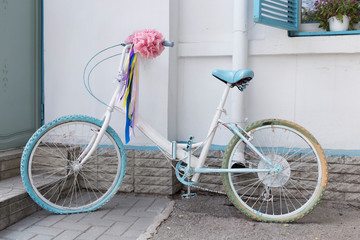 Fototapeta na wymiar Vintage bicycle on white wall background.