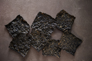 Seasoned seaweed snack on stone background  © mnimage