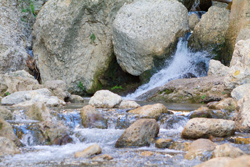 Naklejka na ściany i meble waterfall in forest. Grey stone and water