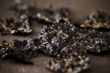 Seasoned seaweed snack on stone background 