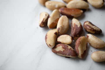 Brazil nuts on white marble background