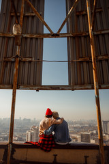 Lovelr young couple sitting together and looking at view of the city