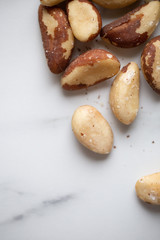Brazil nuts on white marble background