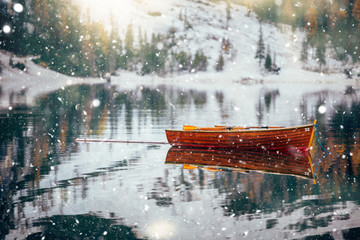 Fototapeta na wymiar Braies lake in winter time with snowfall.