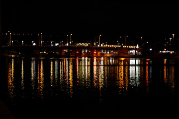 traffic on bridge over river at night