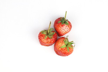 Three strawberries on  white background