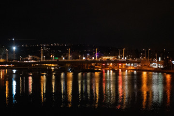 traffic on bridge over river at night