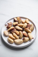Brazil nuts on white marble background