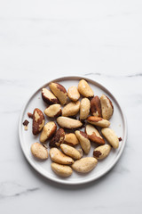 Brazil nuts on white marble background