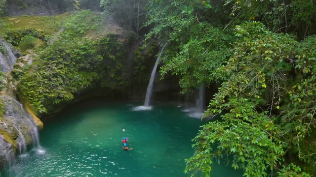 Kawasan Falls on Cebu Island, Philippines. People swimming at the natural pool of the waterfall