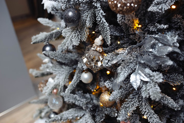 Christmas artificial tree with white snow and decorations toys.