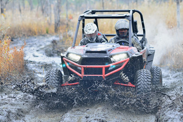 Amazing UTV driving in mud and water at Autumn day. UTV, ATV & offroad © Antonio