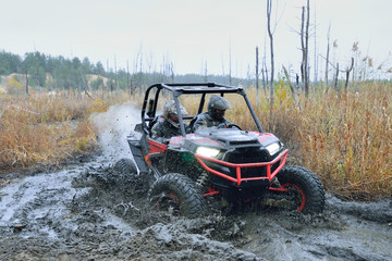 Amazing UTV driving in mud and water at Autumn day. ATV/UTV/4x4 off-road © Antonio