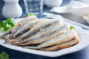 Fried smelt on a white dish, selective focus