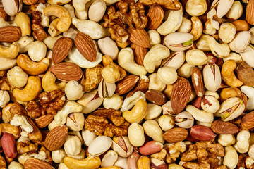 Background of mixed nuts (walnuts, pistachio, almond, peanut, cashew, hazelnut). Healthy eating concept